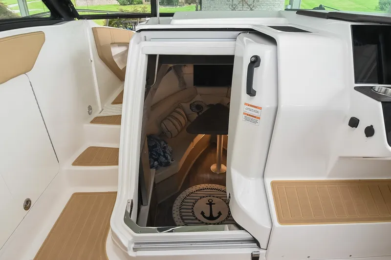Slide: The Image of 2024 Sea Ray Sundancer 320 cabin entrance with stylish interior and nautical decor. - 53