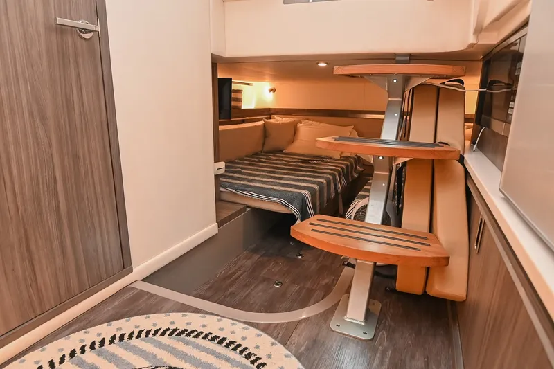 Slide: The Image of 2024 Sea Ray Sundancer 320 cabin interior with modern design and cozy sleeping area. - 64