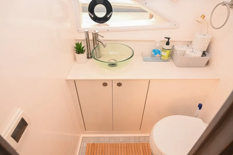 Slide: The Image of Modern bathroom in 2024 Sea Ray Sundancer 320 yacht with glass sink and porthole window. - 71
