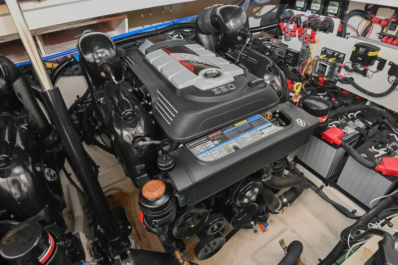 Slide: The Image of Engine compartment of 2024 Sea Ray Sundancer 320, featuring a powerful Mercury engine. - 74