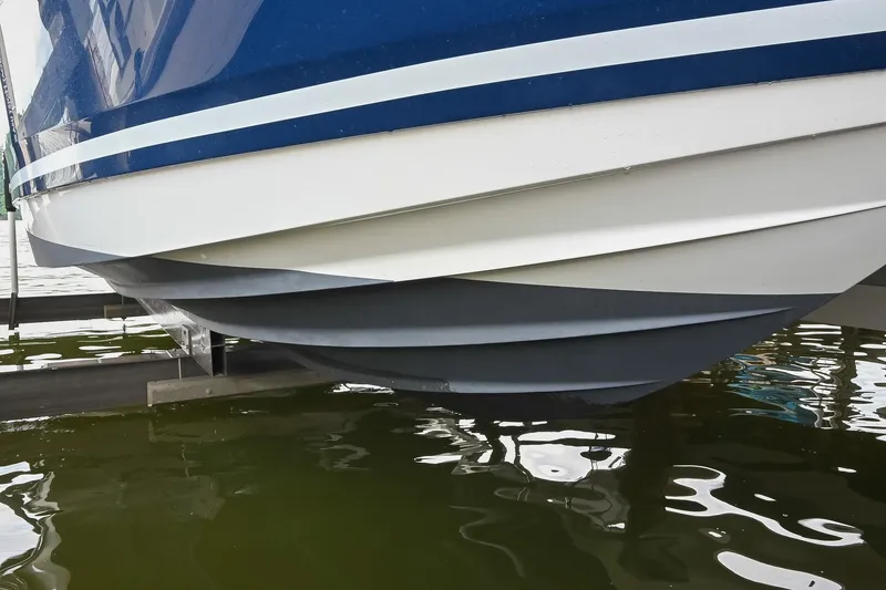 Slide: The Image of 2024 Sea Ray Sundancer 320 hull design above water on lift. - 79