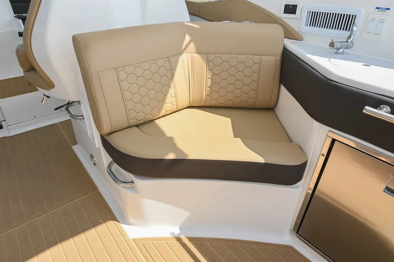 Slide: The Image of 2024 Sea Ray Sundancer 320 interior seating with beige upholstery and modern design. - 23