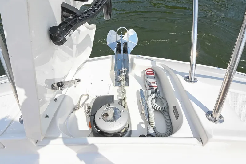 Slide: The Image of 2024 Sea Ray Sundancer 320 anchor compartment with winch and coiled rope. - 52