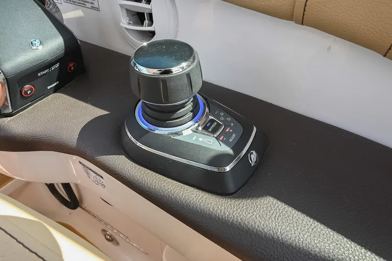 Slide: The Image of 2024 Sea Ray Sundancer 320 joystick control on leather dashboard. - 38