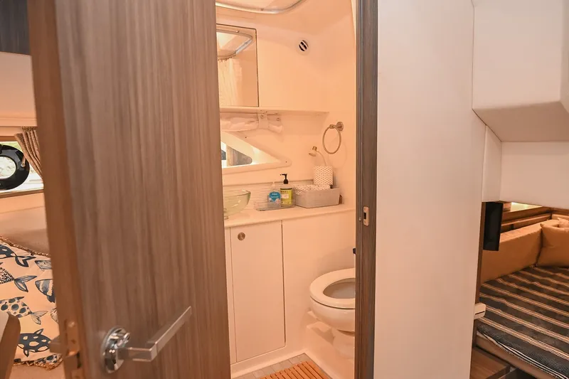Slide: The Image of 2024 Sea Ray Sundancer 320 interior bathroom with modern amenities and cozy cabin. - 70