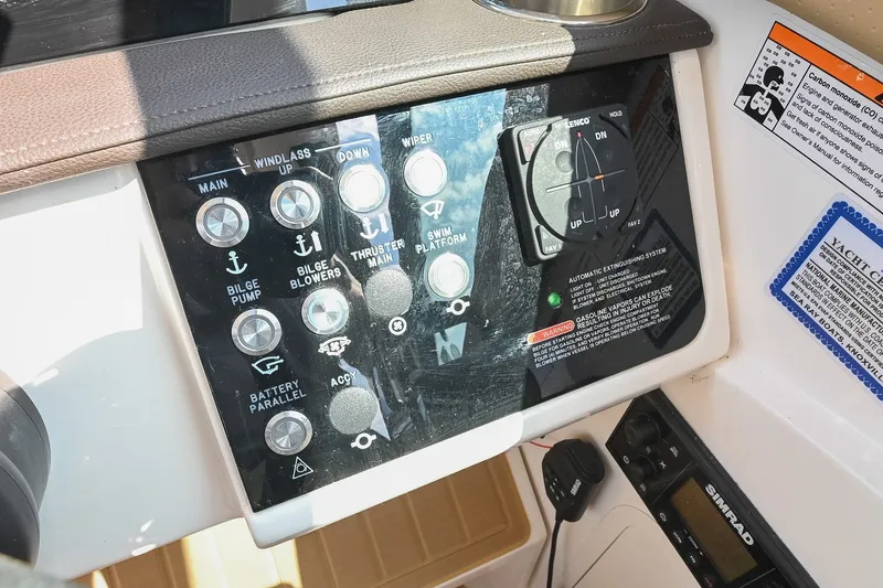 Slide: The Image of Control panel of 2024 Sea Ray Sundancer 320 boat with various switches and labels. - 48