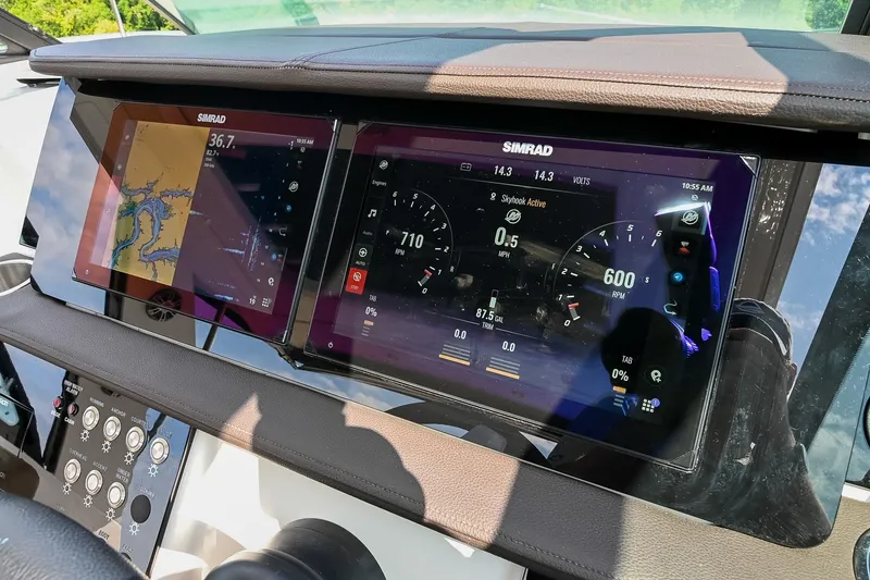Slide: The Image of Dashboard of 2024 Sea Ray Sundancer 320 with Simrad navigation displays. - 44