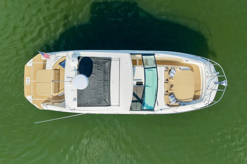 Slide: The Image of 2024 Sea Ray Sundancer 320 yacht, aerial view, cruising on green water. - 14