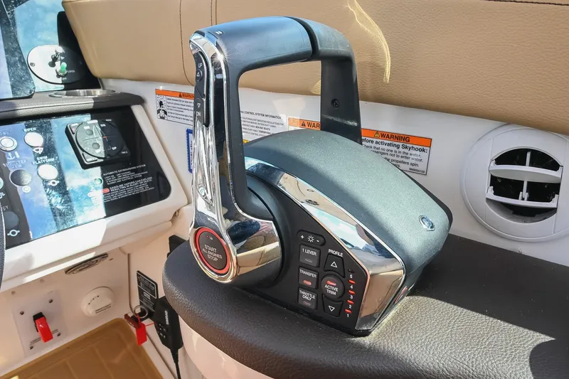 Slide: The Image of 2024 Sea Ray Sundancer 320 throttle control in cockpit, showcasing modern boat technology. - 37