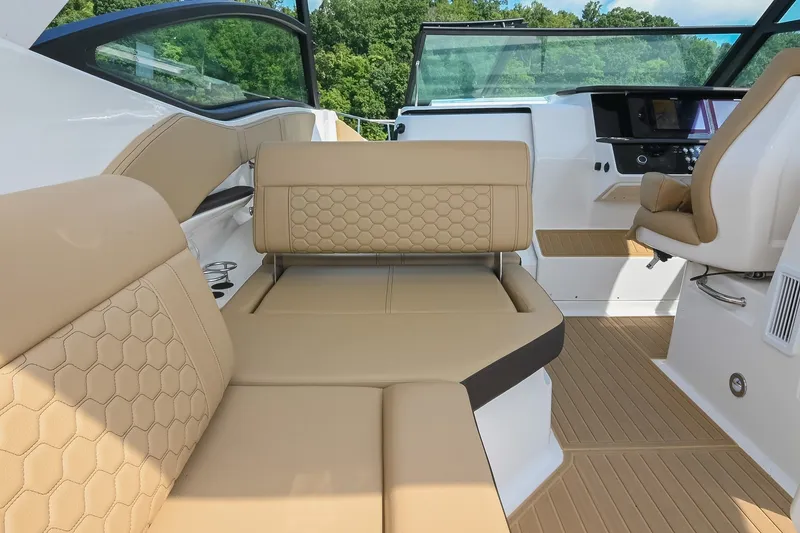 Slide: The Image of 2024 Sea Ray Sundancer 320 interior with beige seating and modern dashboard. - 21