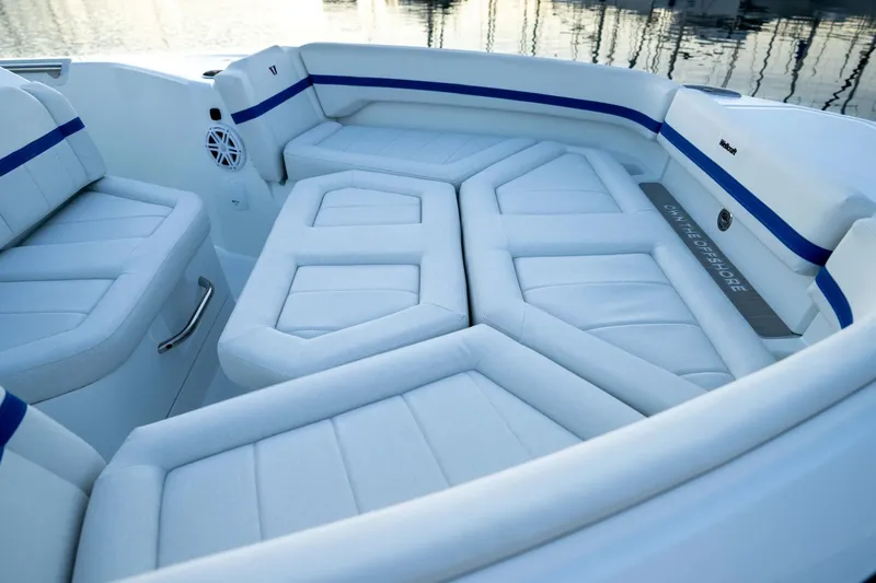 Slide: The Image of Luxurious seating on 2027 Wellcraft 28 T-Top boat, featuring sleek white upholstery. - 13