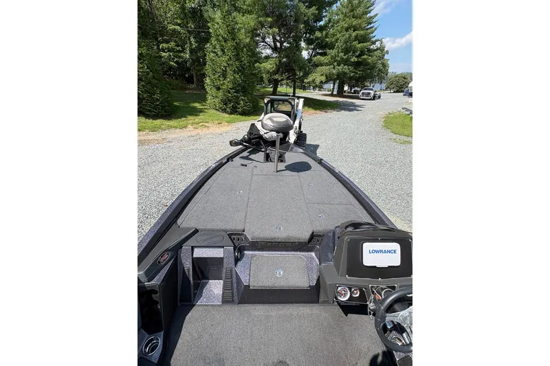 Slide: The Image of 2022 Ranger Z518 boat with Lowrance electronics on a gravel path, surrounded by trees. - 9