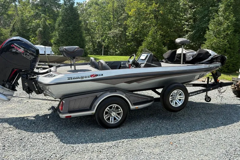 Slide: The Image of 2022 Ranger Z518 boat on trailer, parked outdoors, with Mercury Pro XS engine. - 1