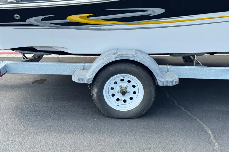 Slide: The Image of Trailer wheel of 2006 Four Winns 200 Horizon boat on asphalt surface. - 28