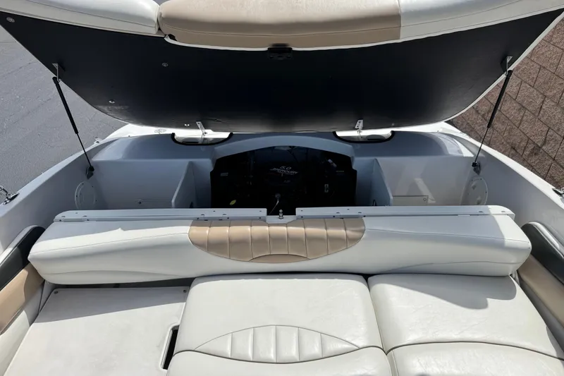 Slide: The Image of 2006 Four Winns 200 Horizon boat interior with open engine compartment and cushioned seating. - 15