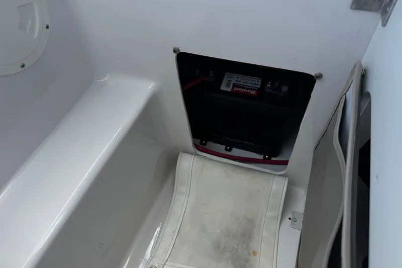 Slide: The Image of 2006 Four Winns 200 Horizon boat battery compartment with visible wiring. - 19