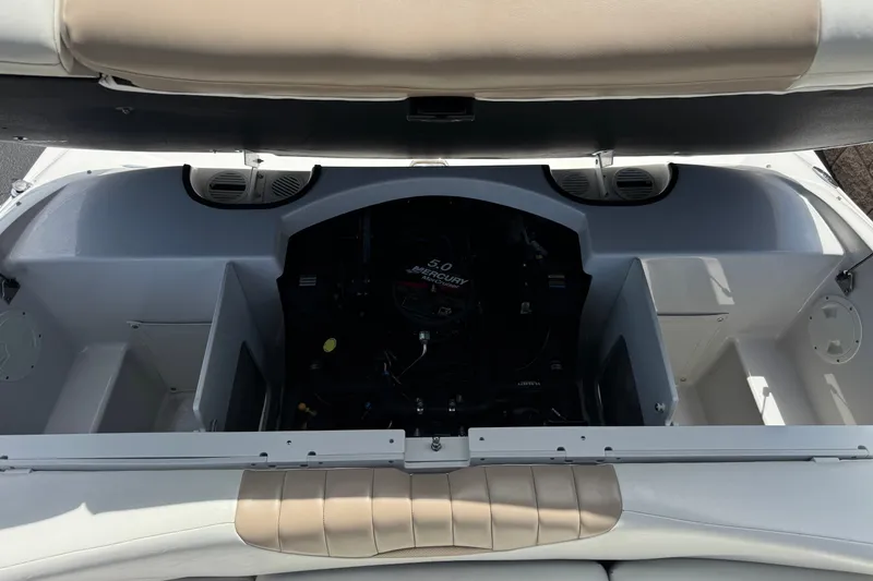 Slide: The Image of 2006 Four Winns 200 Horizon boat engine compartment with open cover, showcasing interior details. - 16