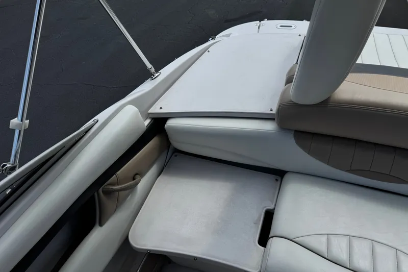 Slide: The Image of Interior view of a 2006 Four Winns 200 Horizon boat, featuring seating and storage areas. - 20