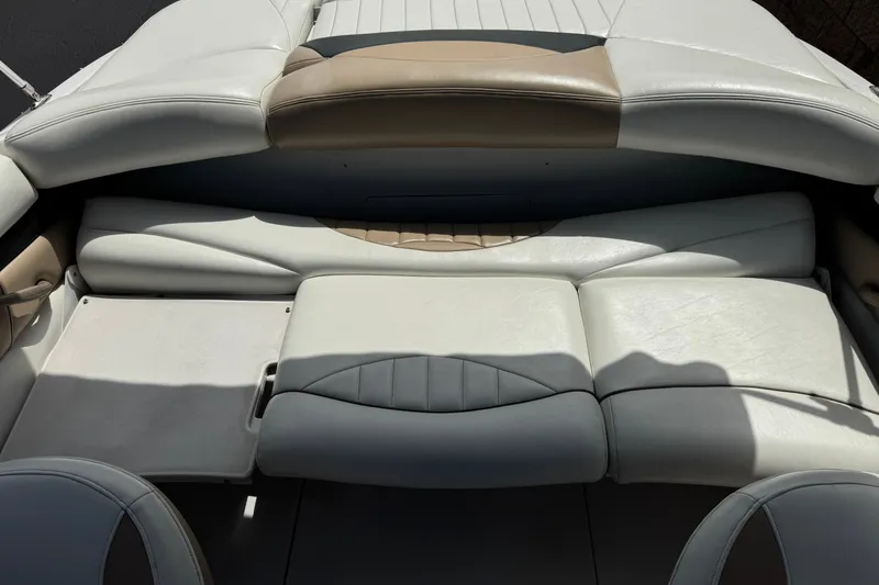 Slide: The Image of 2006 Four Winns 200 Horizon boat interior with white and beige cushioned seating. - 14
