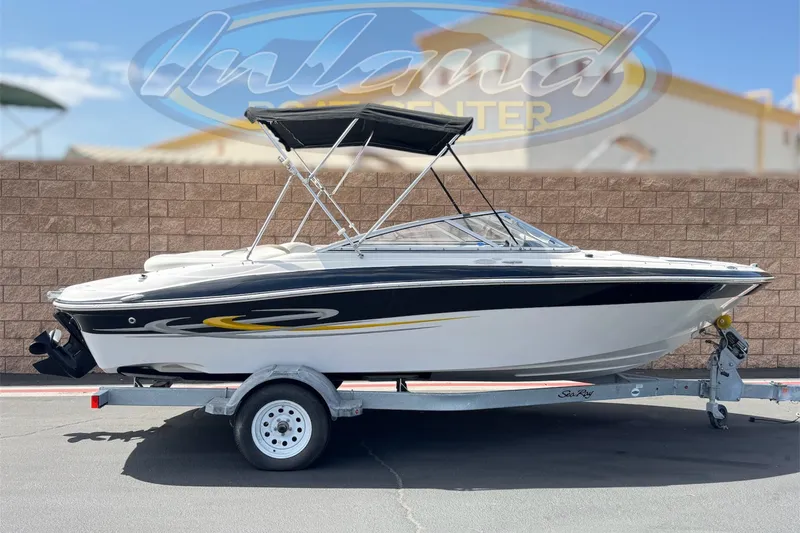 The Image of 2006 Four Winns 200 Horizon boat on trailer, featuring sleek black and white design. - 0