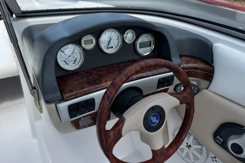 Slide: The Image of 2006 Four Winns 200 Horizon dashboard with wood accents and gauges. - 27