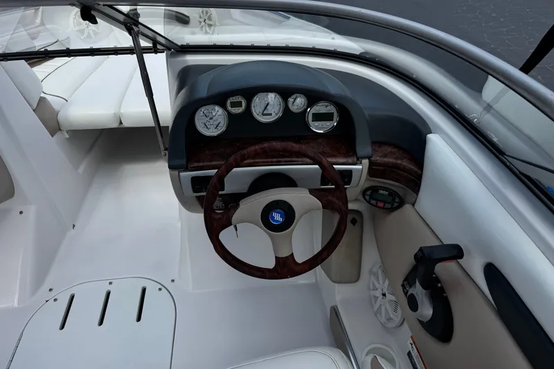 Slide: The Image of 2006 Four Winns 200 Horizon boat dashboard with wood-accented steering wheel and instrument panel. - 26