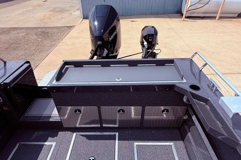 Slide: The Image of 2026 Lund 210 Heavy Gauge boat with dual outboard motors, spacious deck, and storage compartments. - 32