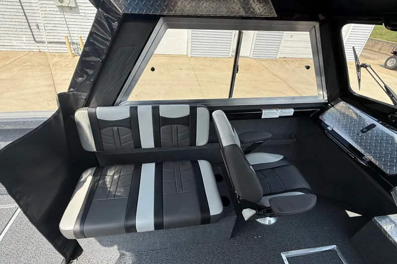 Slide: The Image of Interior of 2026 Lund 210 Heavy Gauge boat with black and gray seating. - 20