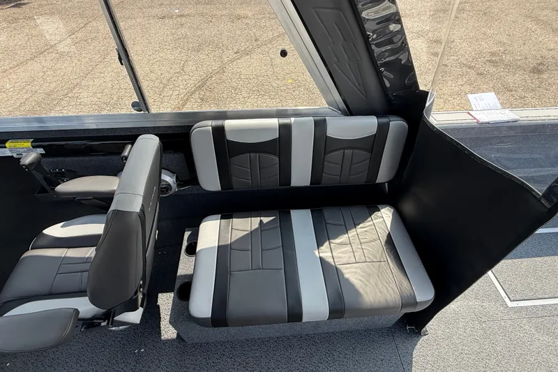 Slide: The Image of Interior seating of 2026 Lund 210 Heavy Gauge boat, featuring modern black and gray upholstery. - 18