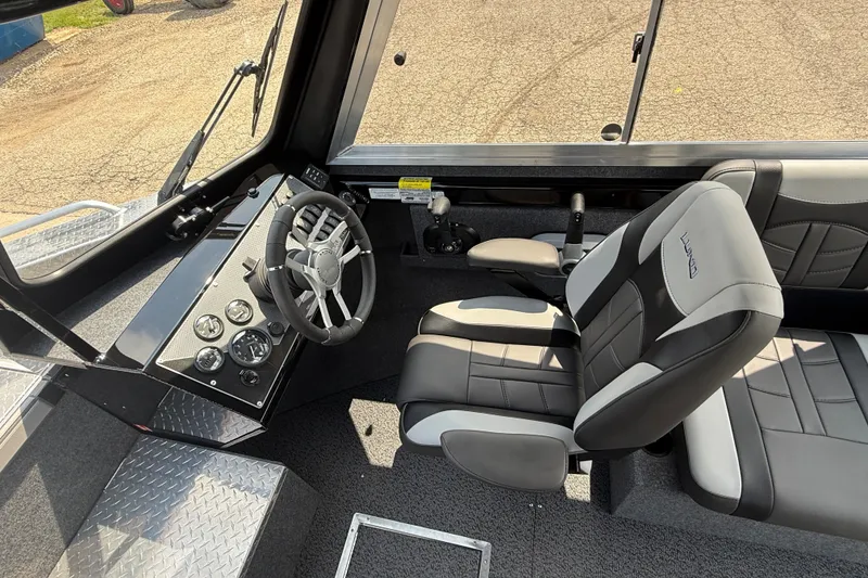 Slide: The Image of Interior of 2026 Lund 210 Heavy Gauge boat with modern steering and seating. - 17