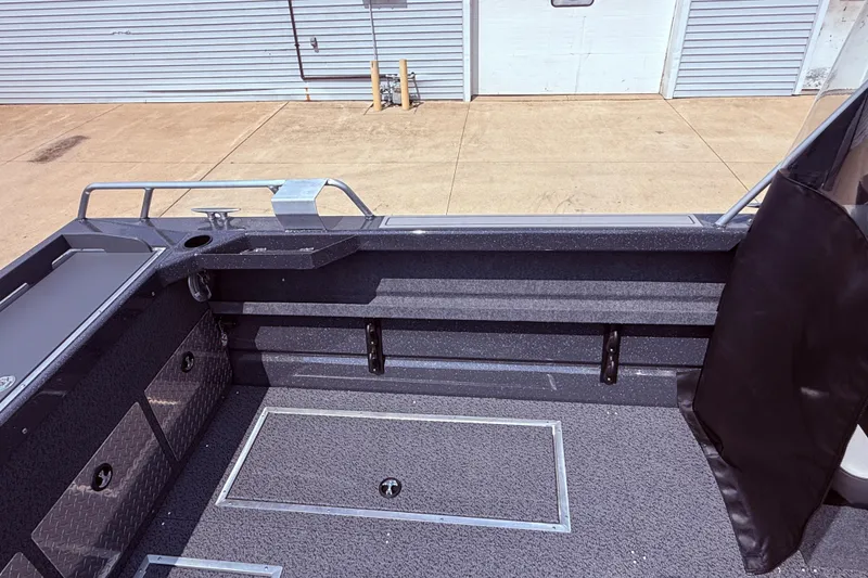 Slide: The Image of Interior view of a 2026 Lund 210 Heavy Gauge boat, showcasing storage compartments. - 31