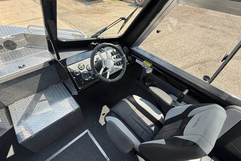 Slide: The Image of Interior of 2026 Lund 210 Heavy Gauge boat with steering wheel and seating. - 13