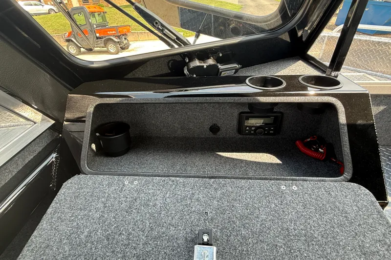 Slide: The Image of Interior of 2026 Lund 210 Heavy Gauge boat with dashboard and storage compartment. - 21