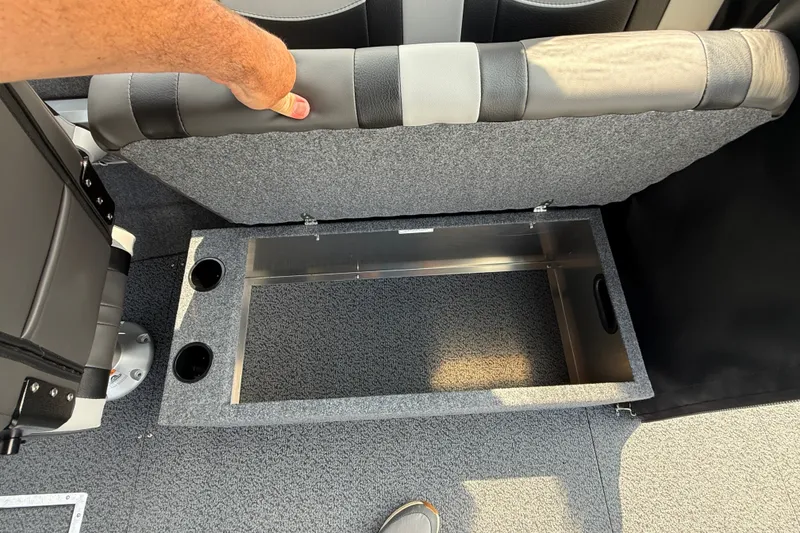 Slide: The Image of Open storage compartment in 2026 Lund 210 Heavy Gauge boat with cup holders. - 19