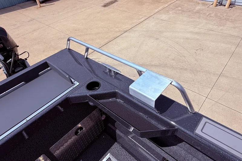 Slide: The Image of 2026 Lund 210 Heavy Gauge boat interior with storage compartments and railing. - 34