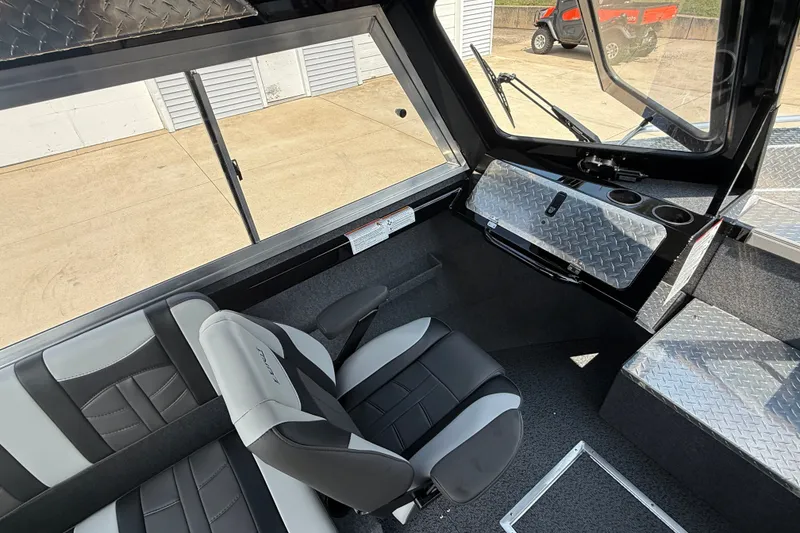 Slide: The Image of Interior of 2026 Lund 210 Heavy Gauge boat with modern seating and diamond plate accents. - 14