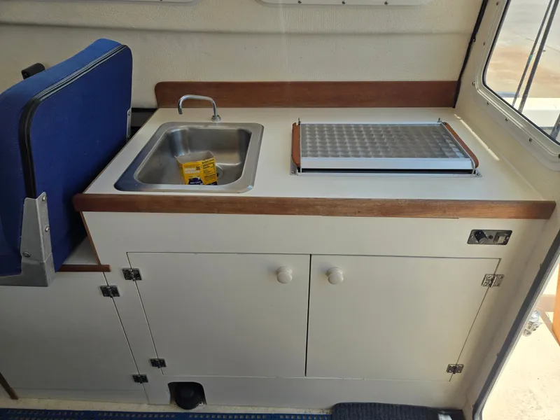 Slide: The Image of Interior of a 2002 C-Dory 22FT Cruiser with a sink and countertop. - 16