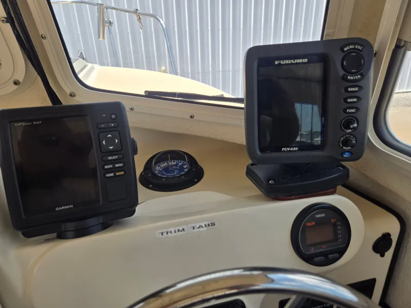 Slide: The Image of The image shows the cockpit of a 2002 C-Dory 22FT Cruiser with navigation equipment. - 17