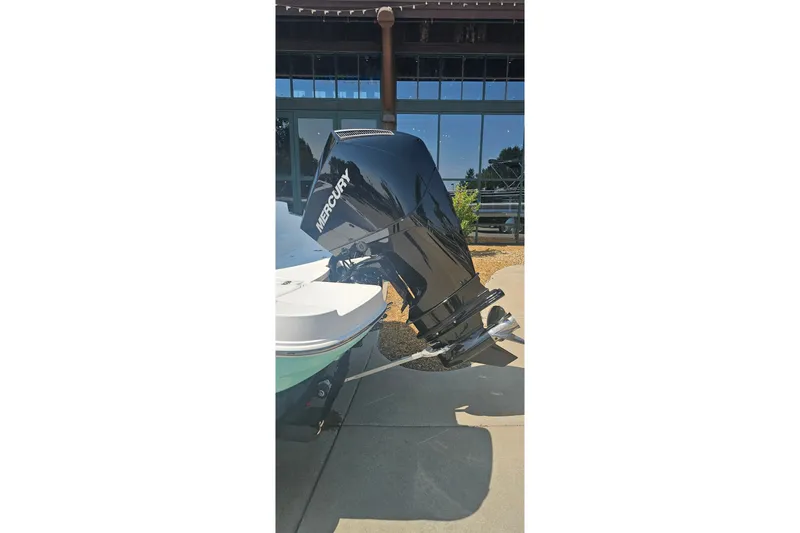 Slide: The Image of 2026 Tahoe 2150 CC boat with Mercury outboard motor displayed outdoors. - 8