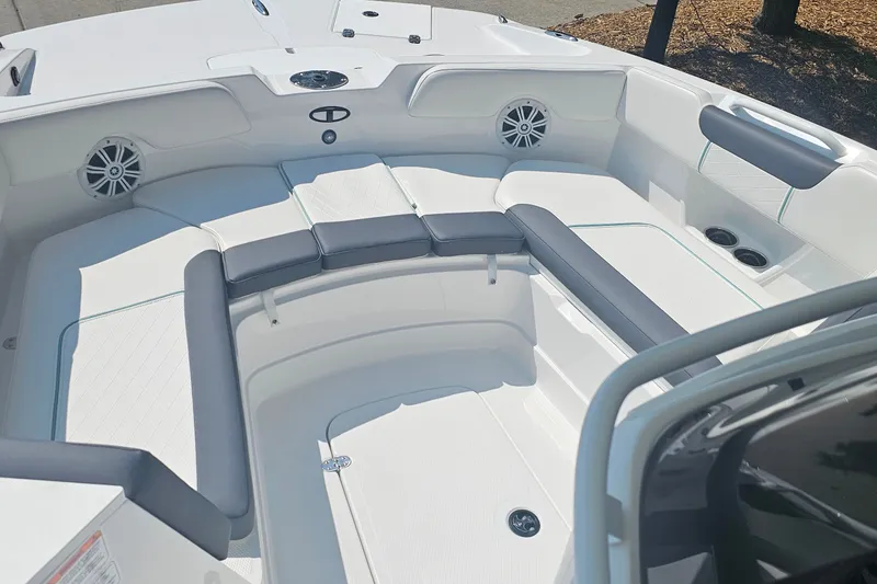 Slide: The Image of 2026 Tahoe 2150 CC boat interior with cushioned seating and built-in speakers. - 5
