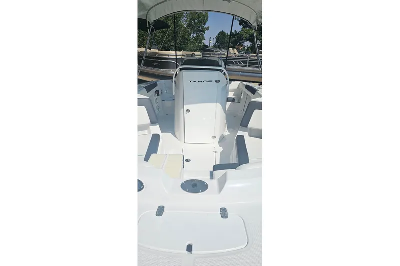 Slide: The Image of 2026 Tahoe 2150 CC boat interior with seating and console under canopy. - 4