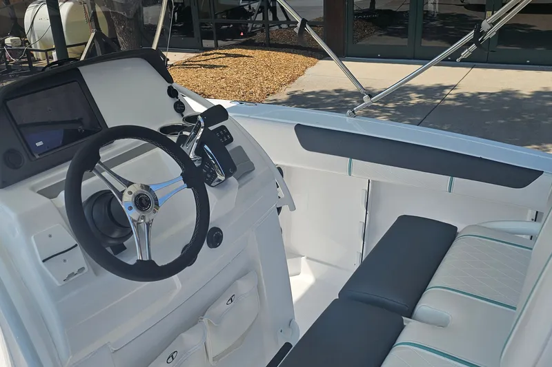 Slide: The Image of Interior view of 2026 Tahoe 2150 CC boat, featuring sleek steering and seating. - 6