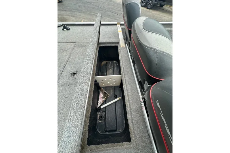 Slide: The Image of 2006 Bass Tracker Pro 17 boat interior with open storage compartment and seating. - 15