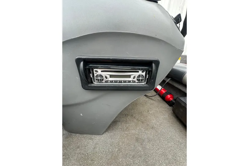 Slide: The Image of 2006 Bass Tracker Pro 17 boat dashboard with stereo system. - 18