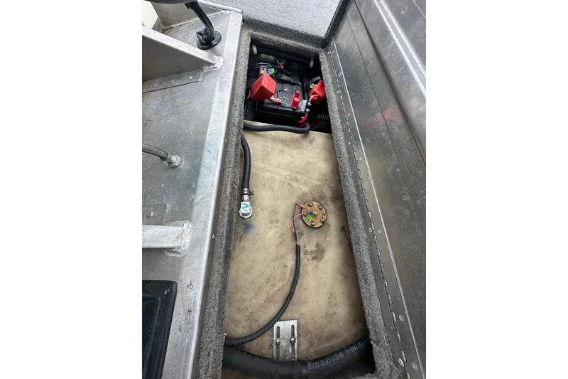 Slide: The Image of 2006 Bass Tracker Pro 17 boat interior showing battery compartment and wiring. - 14