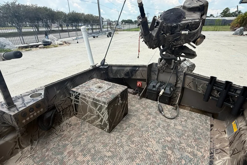 Slide: The Image of 2024 Pro-Drive 1854 SBX TD boat interior with camouflage design and motor. - 8