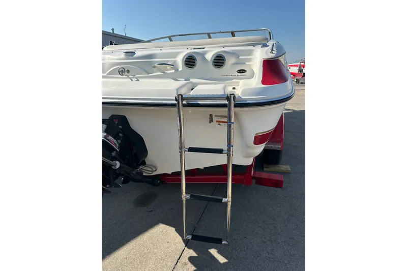 Slide: The Image of 2004 Larson SEi 190 boat rear view with ladder and motor on trailer. - 7