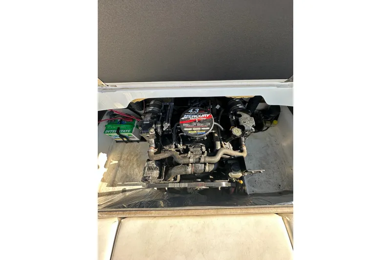 Slide: The Image of Engine compartment of a 2004 Larson SEi 190 boat, featuring a Mercury engine. - 11