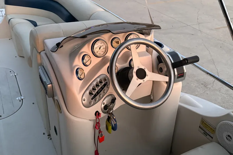 Slide: The Image of 2005 Starcraft SD 201 boat dashboard with steering wheel and gauges. - 14