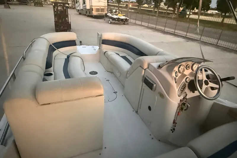 Slide: The Image of 2005 Starcraft SD 201 boat interior with plush seating and steering console. - 15